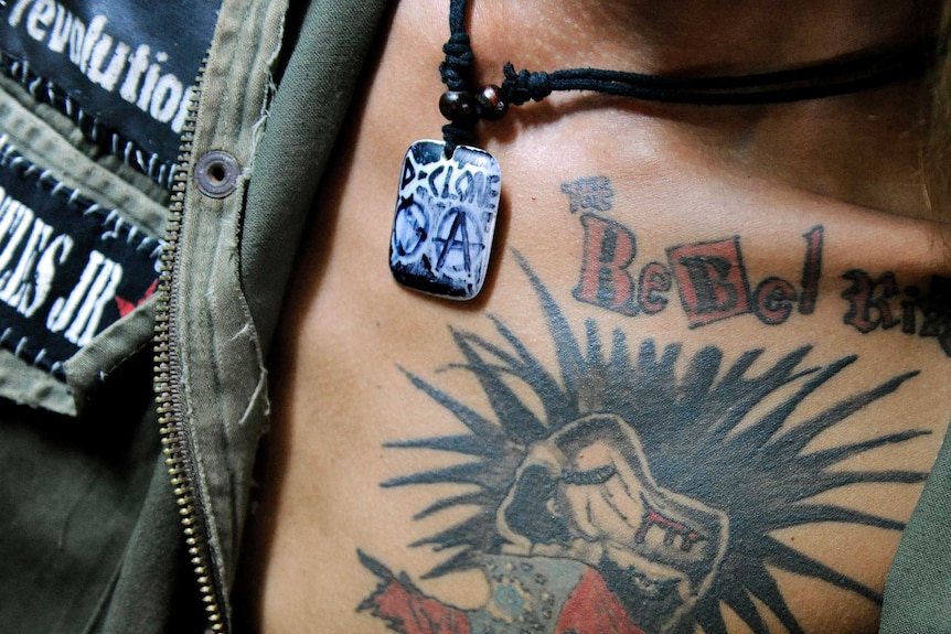 Oakar, member of punk band Rebel Riot, wears a tattoo with the band symbol