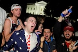 Young men celebrate in front of the White House.
