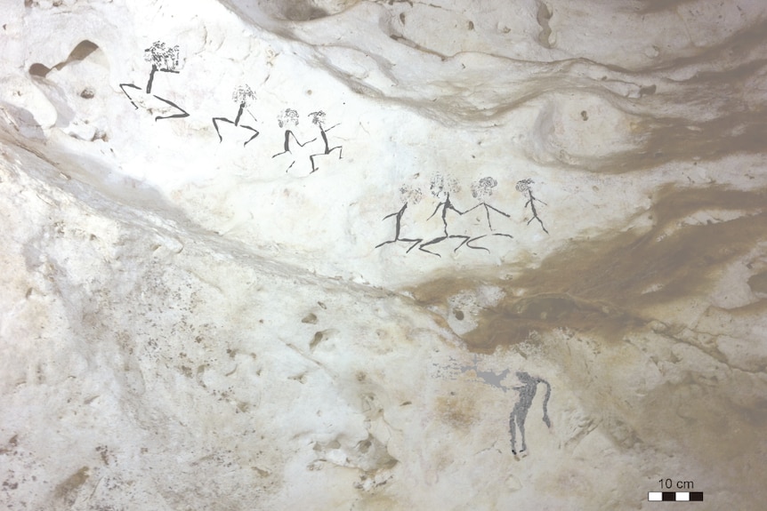 Human figures painted on cave wall in Borneo.