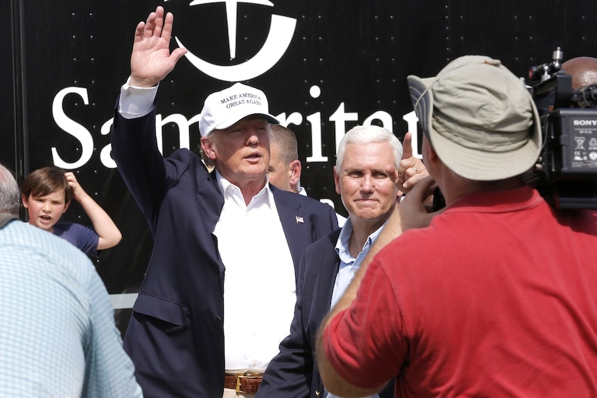 Republican presidential nominee Donald Trump and Republican U.S. vice presidential candidate Mike Pence speak with flood victims outside Greenwell Springs Baptist Church in Central, Louisiana, U.S. August 19, 2016.