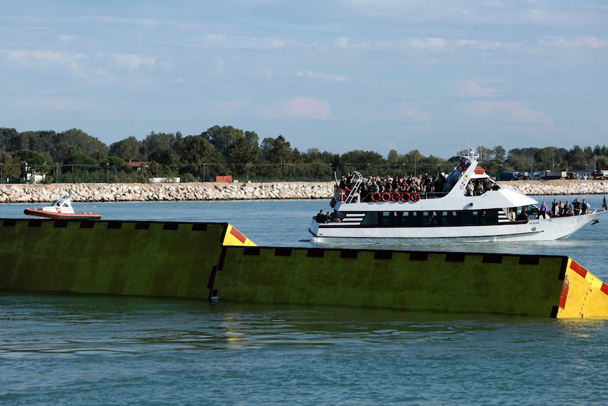 A yellow barrier is seen on the waters.