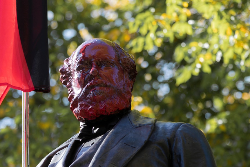 The head of a statue painted red 