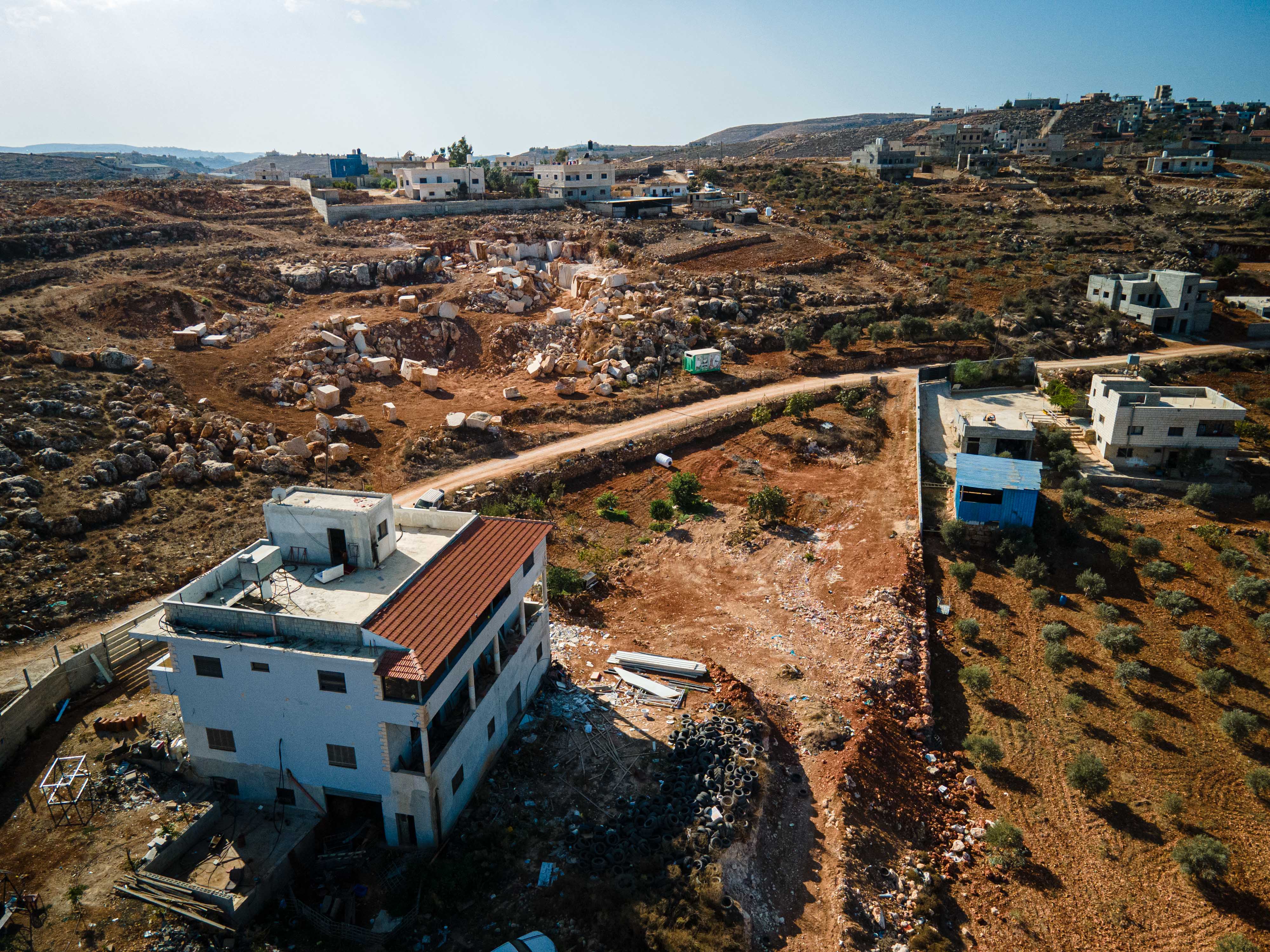 A drone shot of several houses on a hill 