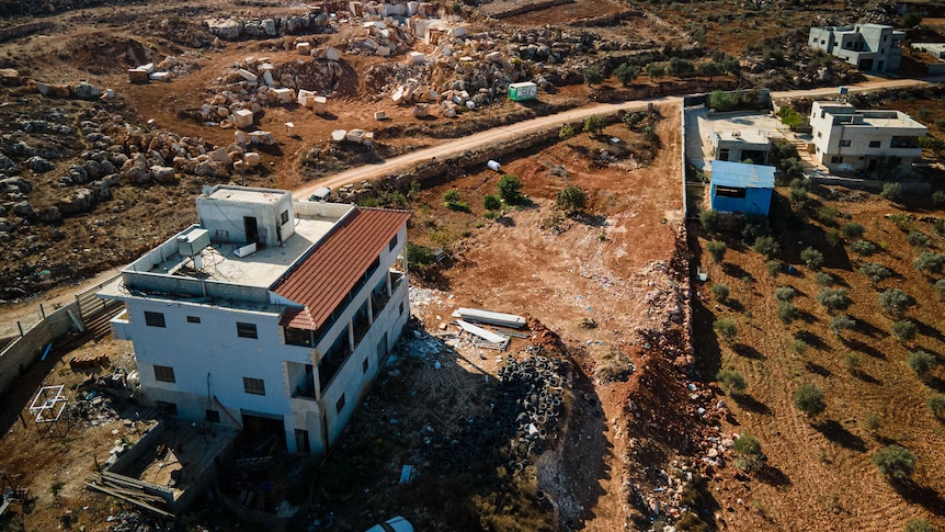 A drone shot of several houses on a hill 