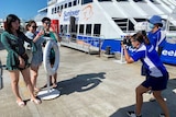 Chinese tourists being photographed alongside a reef tour boat
