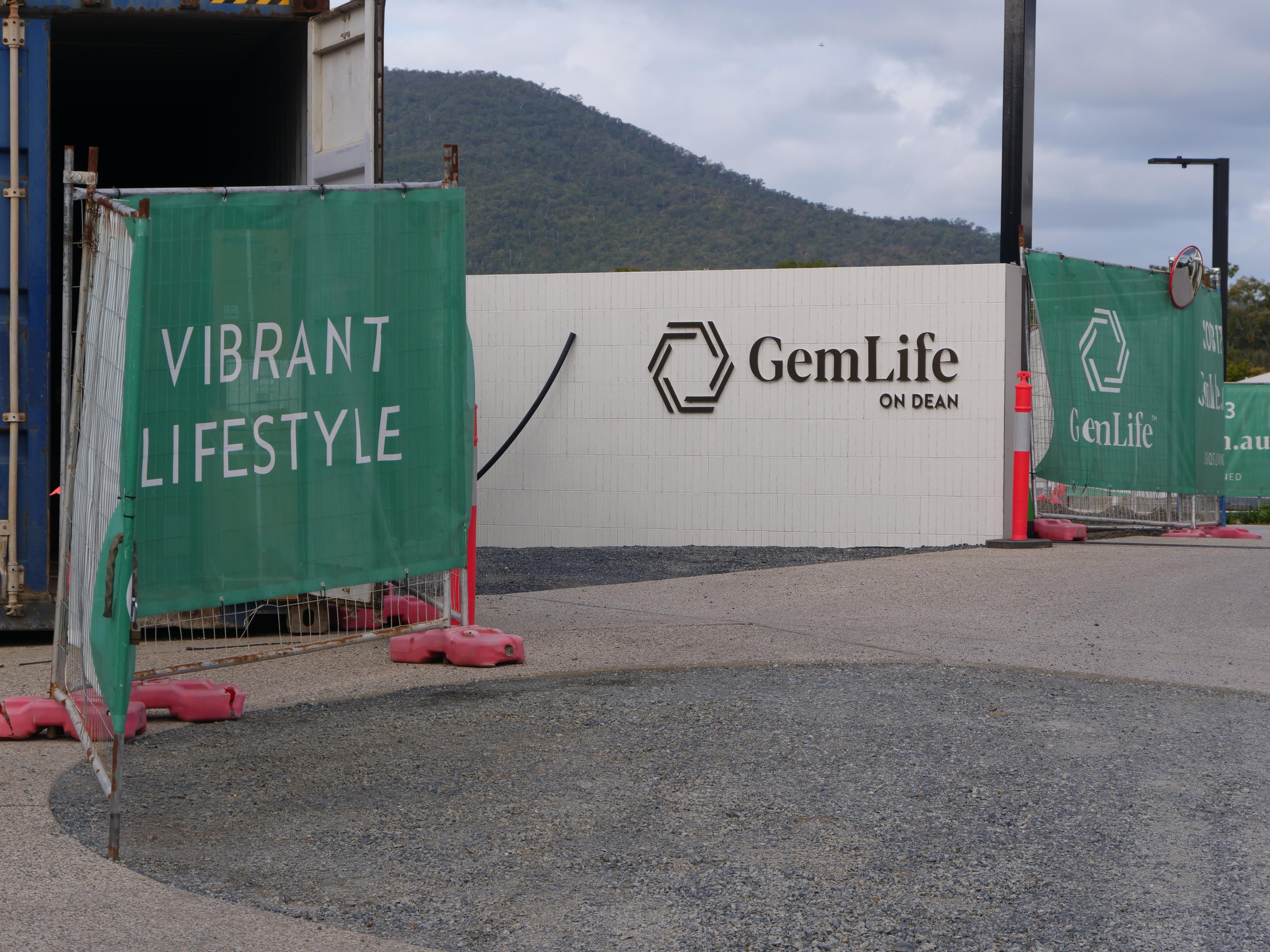 Green construction wrapping at the entrance of a sign saying 'Gemlife' 