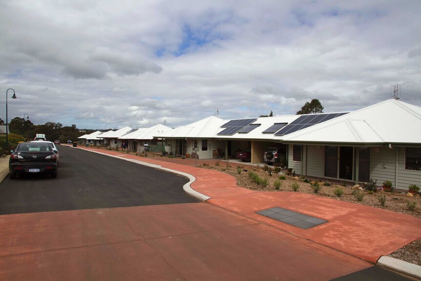 Six residential buildings line the side of a country street in Kojonup in WA's Great Southern.