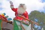 Father Christmas waves to the crowd in Adelaide