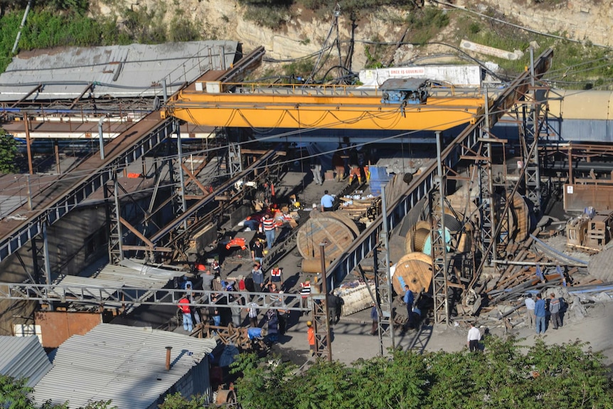 People gather at a collapsed mine in Turkey as rescue crews try to reach trapped workers