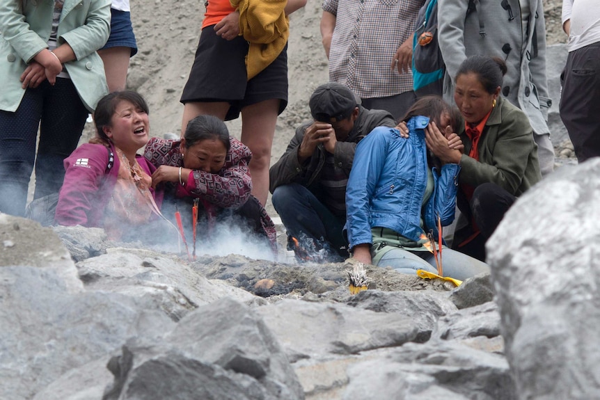 Grieving relatives following a landslide in Xinmo village in Maoxian County in southwestern China's Sichuan Province.