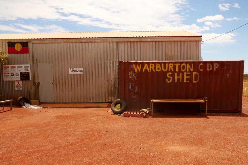 A shipping container painted with 'Warburton CDP Shed'