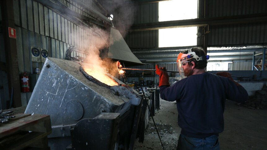 Furnaceman Jason McKeone removes slag from moulten cast iron in the electric furnace, he started at Billman's in 2011.