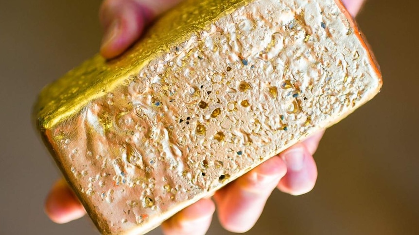 A gold brick in someone's hand