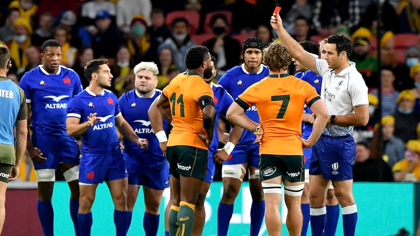 Rugby union player being red carded by the referee during a match 