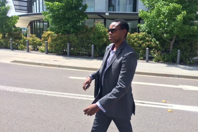 Donald Tawanda Savanhu crossing the street outside of the ACT Magistrates Court.