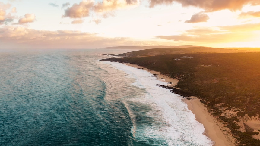 An aerial shot of a magnificent stretch of coastline in low light.