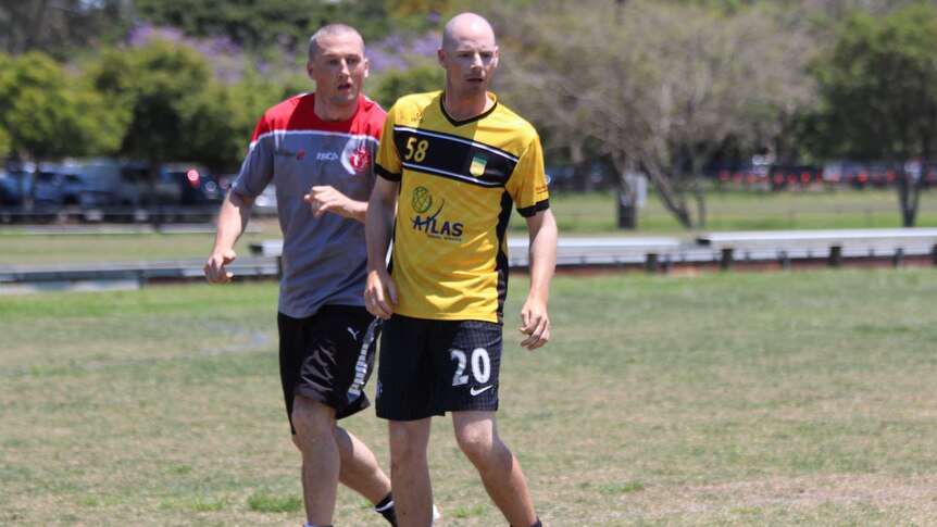 BMUFC president Keith White (R) takes part in charity football tournament at Mitchelton in Brisbane.