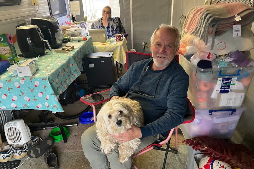 Two people in a caravan annexe.