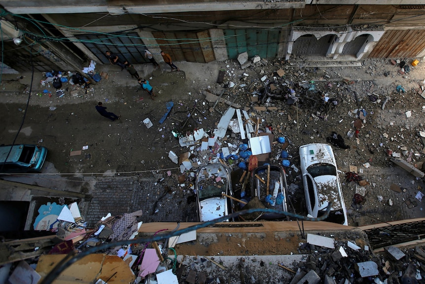 Damaged cars and debris after an Israeli air strike in Gaza City.