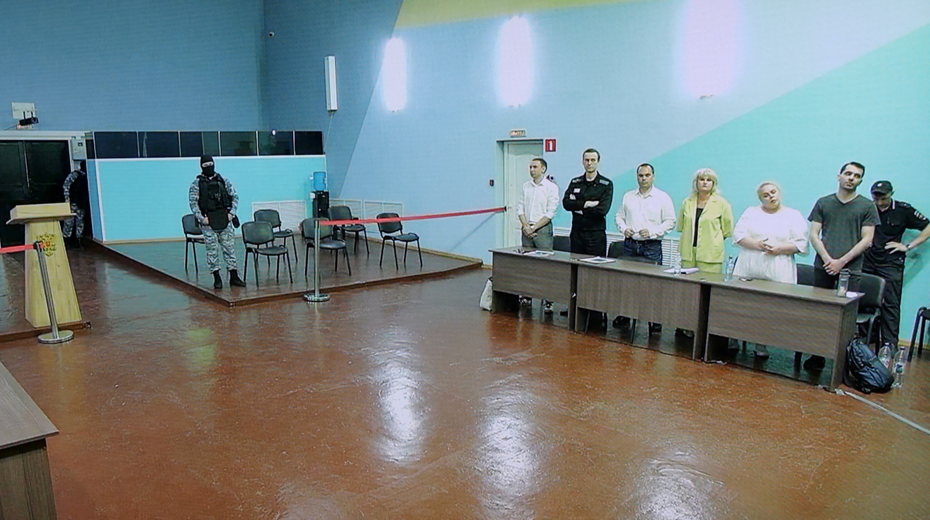 Alexei Navalny, his lawyers Olga Mikhailova and Vadim Kobzev and other participants appear on a screen via video link