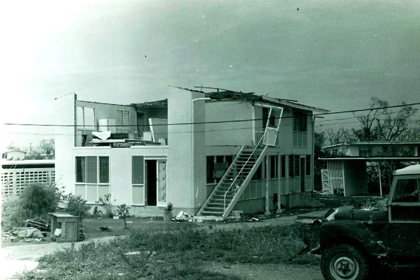 Black and white picture of a badly damaged house after a cyclone.