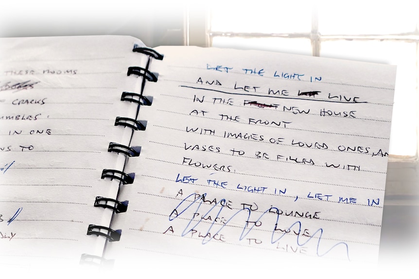 A notebook with an original handwritten poem including the lines 'let the light in, and let me live'.