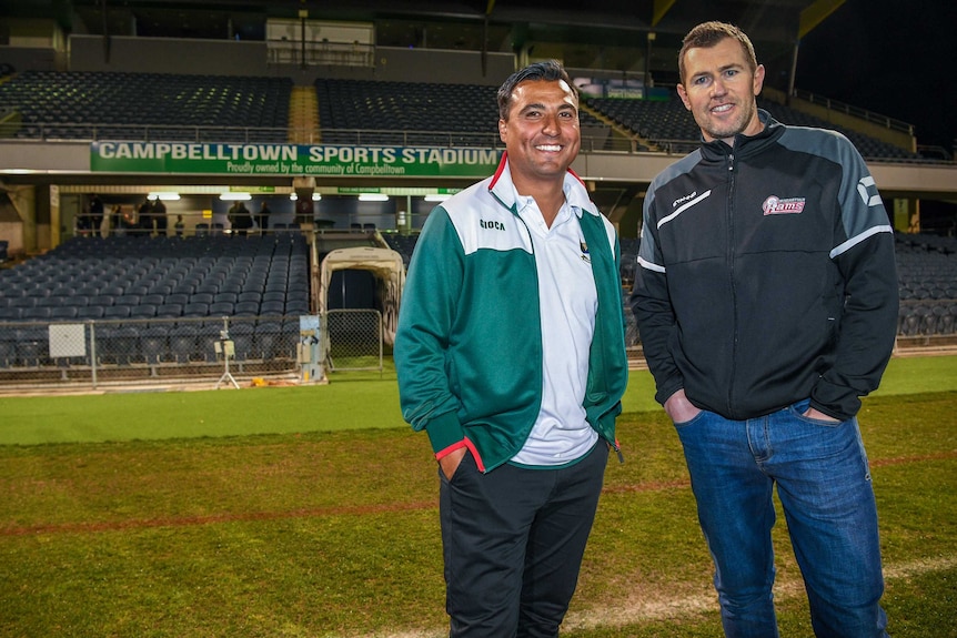 Nick Carle and Brett Emerton smile as they pose for a photograph at Campbelltown Sports Stadium.