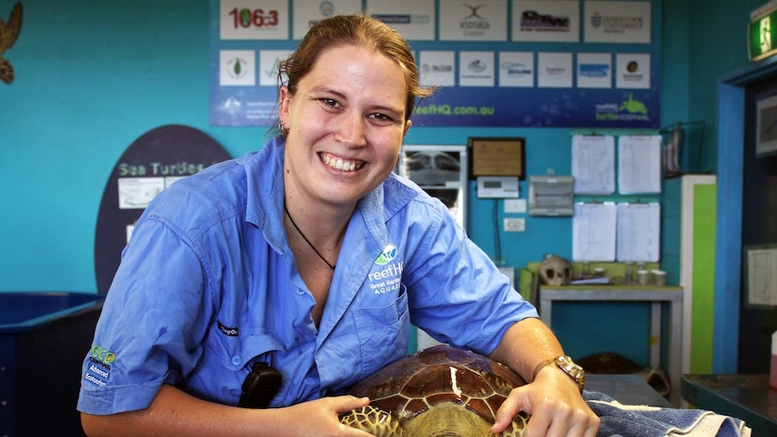 Aquarist Krystal Huff with Diamond the turtle at the Reef HQ Turtle Hospital in Townsville.