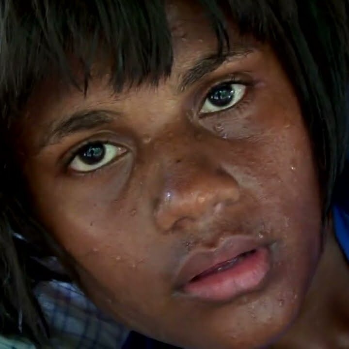 A profile of a young melanesian girl with a short bob haircut looking up in shock or surprise