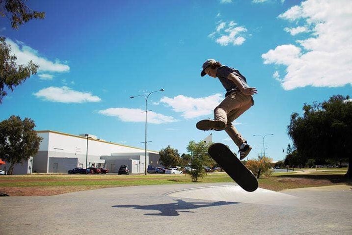 A teenager doing a jump on a skateboard.