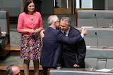 Malcolm Turnbull and Joe Hockey embrace in Parliament