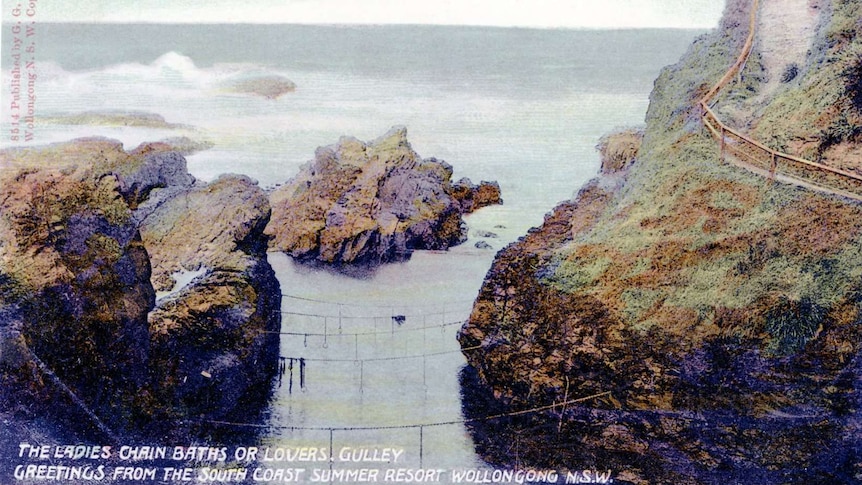 A historic postcard depicting an ocean pool with chains suspended across it