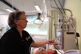 Nursing lecturer inside a simulation hospital used for practical examinations.