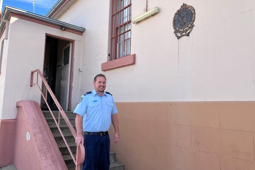 A police officer walking down the stairs.