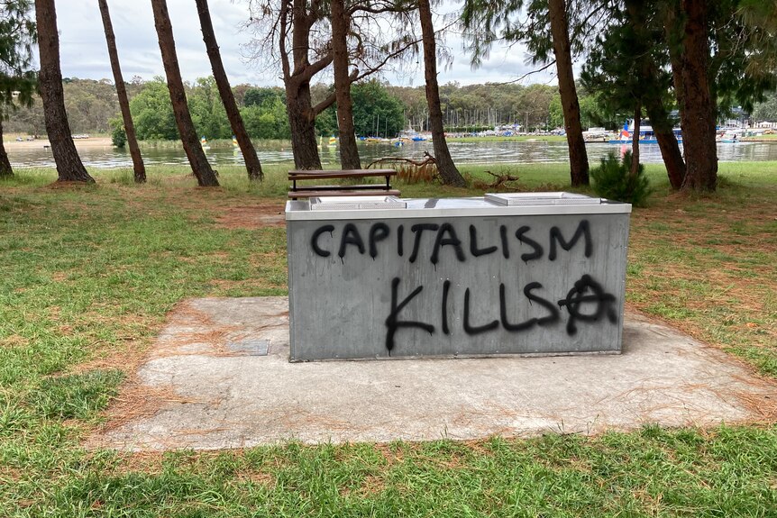 Graffiti on a BBQ that reads: Capitalism kills.