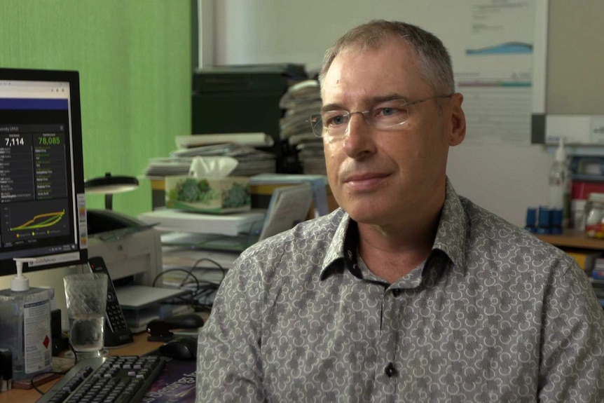 Dr Marek Steiner sitting at his desk in his consulting room