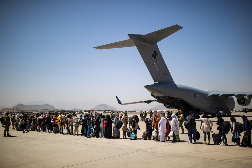 Afghan families lining up on the tarmac