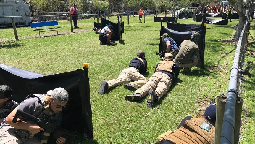 Crowds of gamers play at gel ball game in bushland at Heritage Park outside facility at Pimpama on Queensland's Gold Coast.