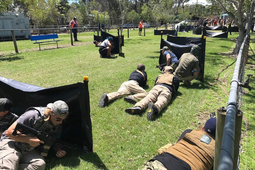 Crowds of gamers play at gel ball game in bushland at Heritage Park outside facility at Pimpama on Queensland's Gold Coast.