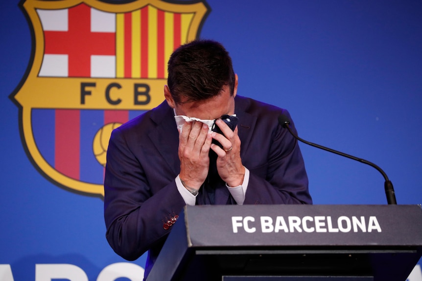Messi buries his face in a handkerchief as he bids FC Barcelona a tearful farewell