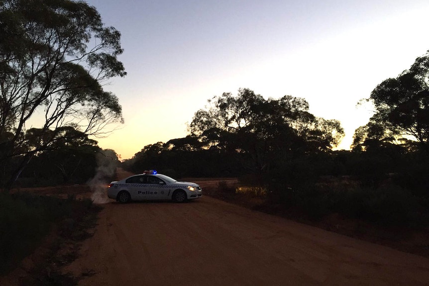 A South Australian police car blocks off a dirt road