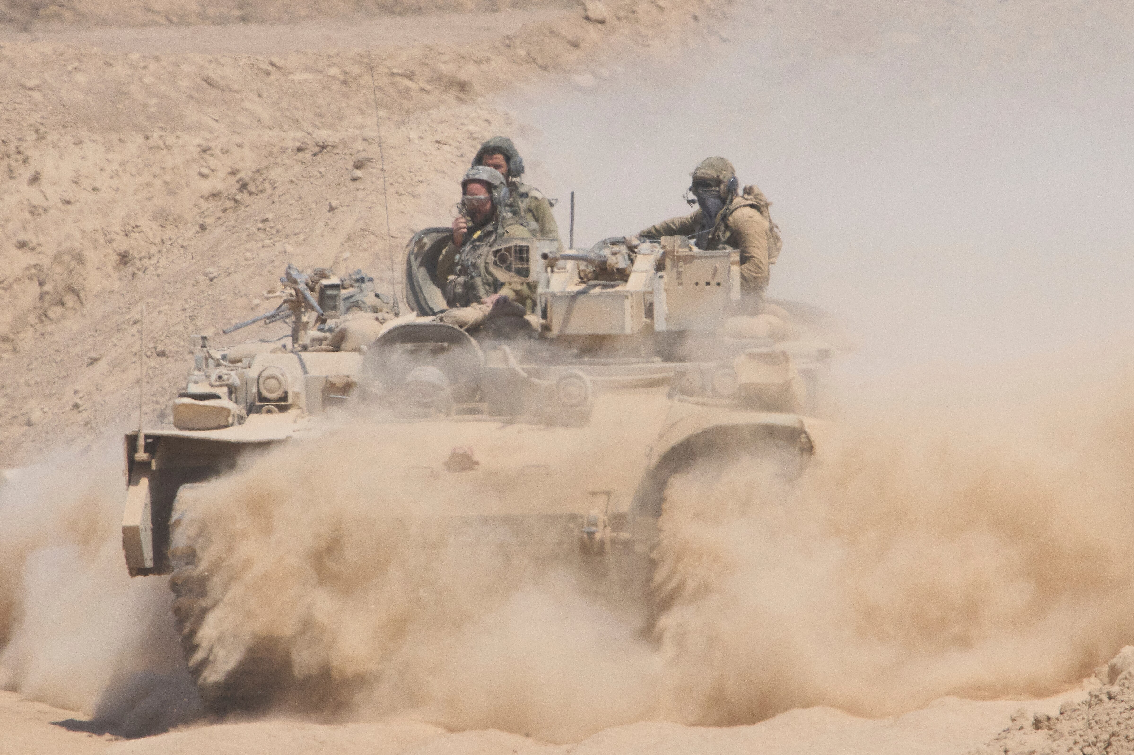 Israeli soldiers drive on their armoured personnel carrier 