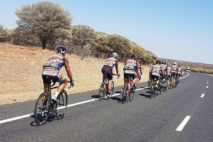 A group of cyclists on a bitumen country road.