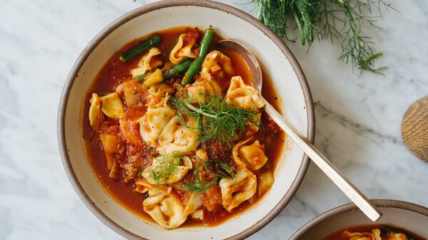 A bowl of tortellini soup