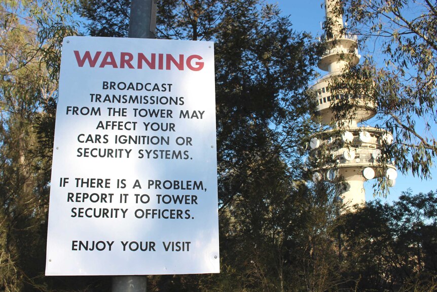 A sign warning about possible issues with cars at Telstra Tower.
