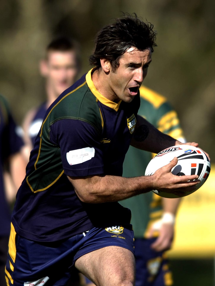 Andrew Johns holds the ball while running at Kangaroos training