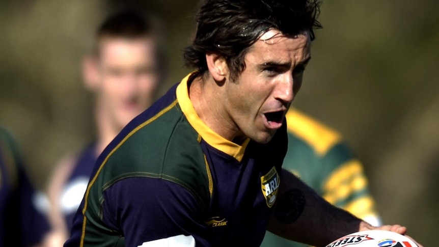 Andrew Johns holds the ball while running at Kangaroos training