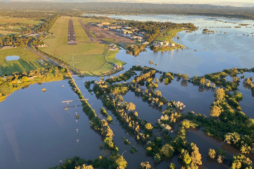 An aerial view of widespread flooding near an airstrip.