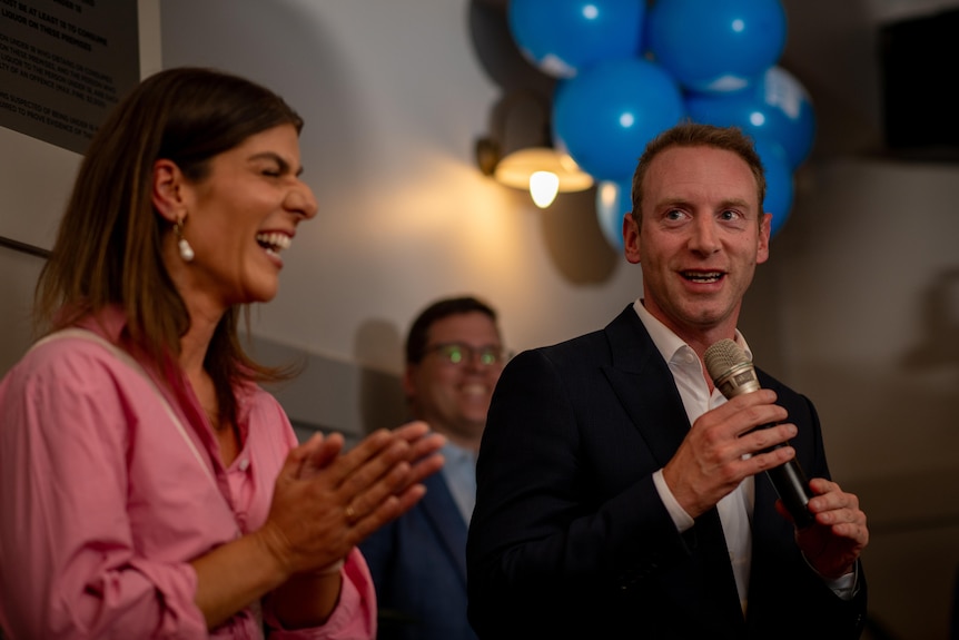 Anna Finizio and David Speirs address supporters and smile at Liberal party function