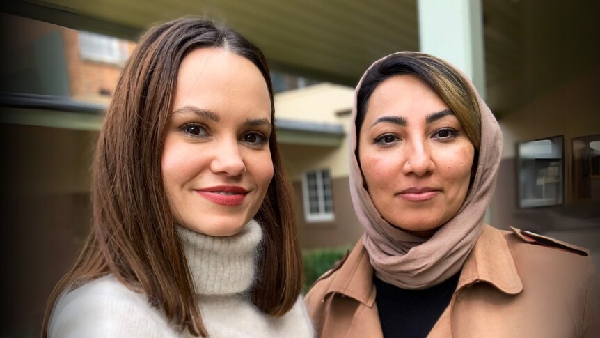 Two women, one wearing hijab.